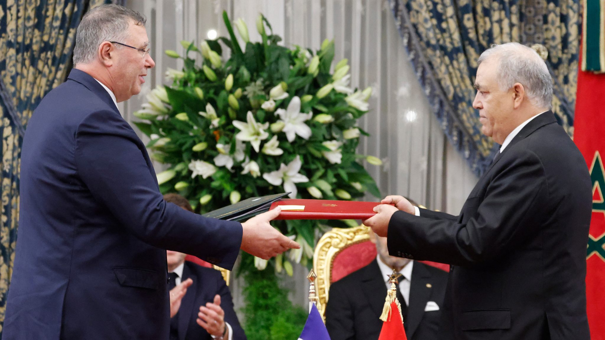 الرئيس التنفيذي لشركة طوطال "باتريك بويان" يتبادل الوثائق الموقعة مع وزير الداخلية المغربي "عبد الوافي لفتيت" في 28 أكتوبر 2024 في القصر الملكي بالرباط